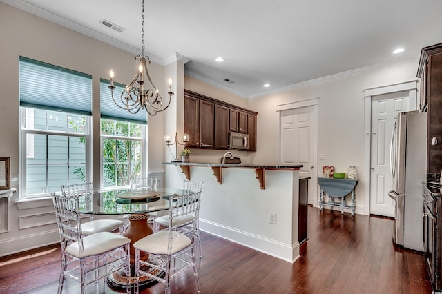 1348 Peterson St, Myrtle Beach, SC 29577 - dining area featuring a chandelier, ornamental molding, dark wood-style floors, and recessed lighting