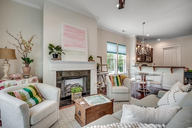 1348 Peterson St, Myrtle Beach, SC 29577 - living area with a chandelier, wood finished floors, crown molding, a fireplace, and recessed lighting