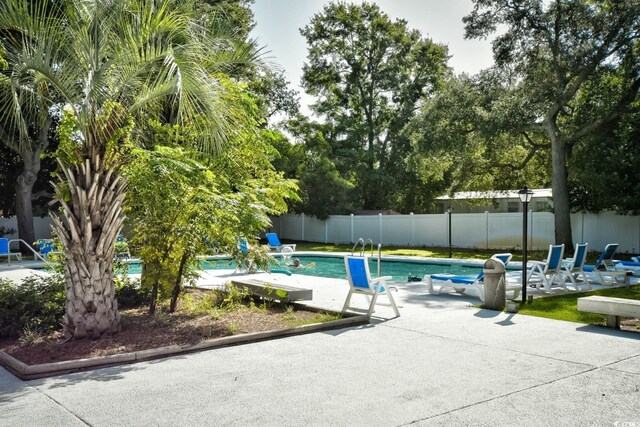 view of swimming pool featuring a patio area