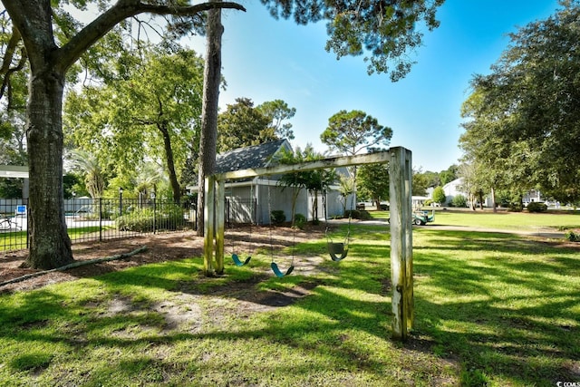 view of community featuring a yard and fence