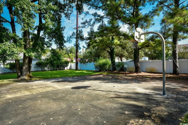 view of basketball court with community basketball court and fence