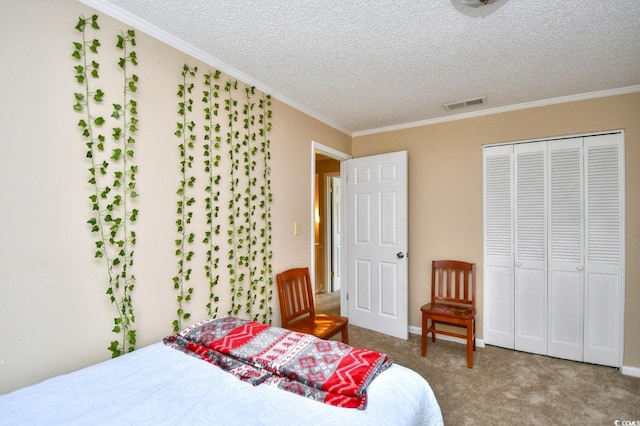 carpeted bedroom with a closet, a textured ceiling, and ornamental molding