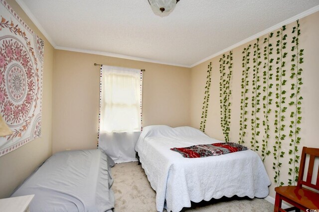 bedroom with light carpet, a textured ceiling, and crown molding