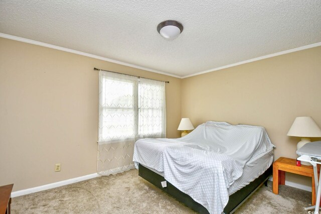 carpeted bedroom with ornamental molding and a textured ceiling