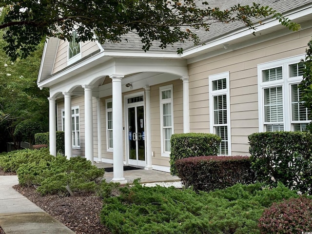 view of exterior entry featuring a porch