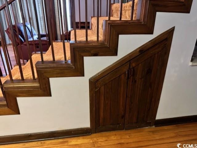 staircase with hardwood / wood-style flooring