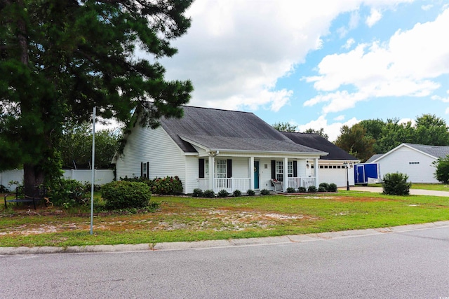 view of front of property with a front yard, a garage, and a porch