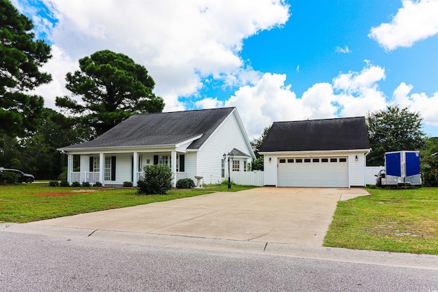 view of front facade with covered porch, a front yard, and a garage