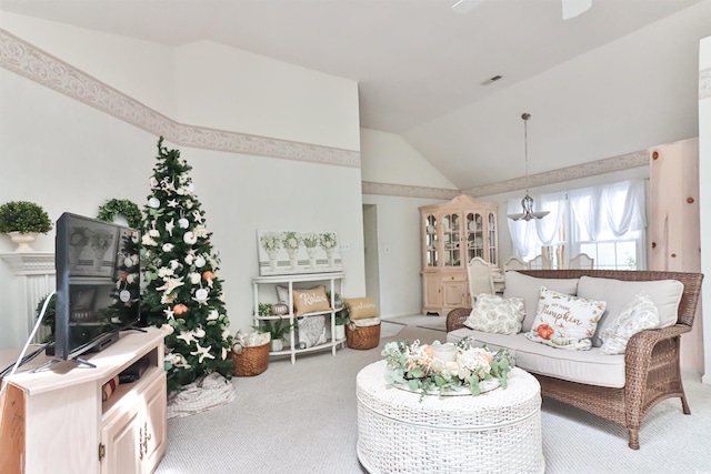 carpeted living room featuring ceiling fan and high vaulted ceiling