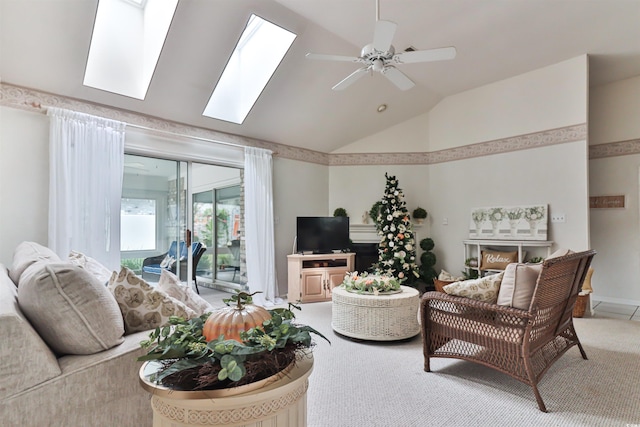 carpeted living room featuring ceiling fan and lofted ceiling with skylight