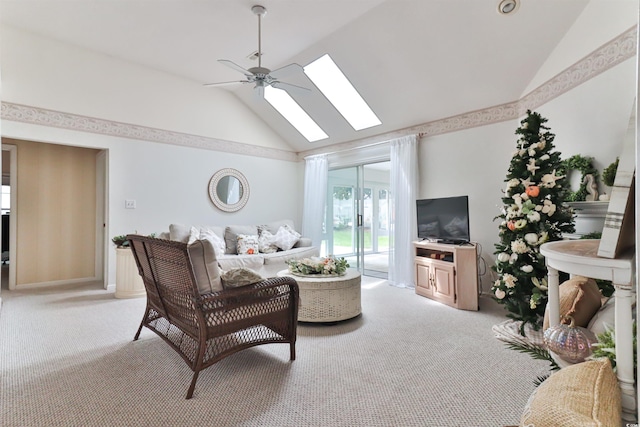 carpeted living room with ceiling fan, high vaulted ceiling, and a skylight