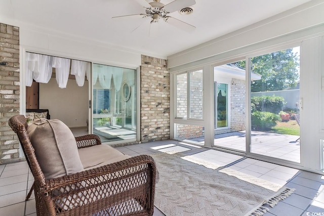 interior space featuring ceiling fan, light tile patterned flooring, and a healthy amount of sunlight