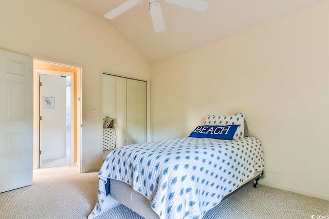 bedroom with carpet flooring, ceiling fan, a closet, and vaulted ceiling