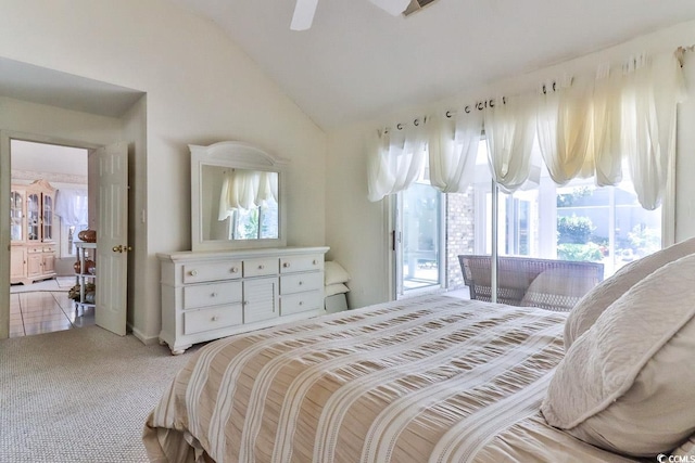 bedroom featuring multiple windows, light colored carpet, access to outside, and vaulted ceiling