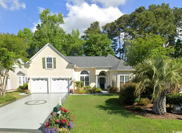 view of front of home featuring a garage and a front yard