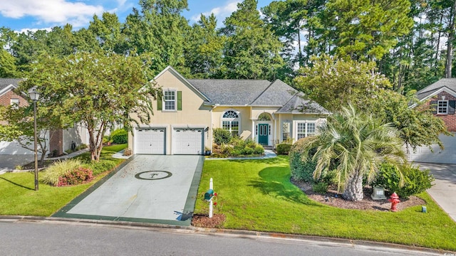 view of front of home featuring a shingled roof, concrete driveway, stucco siding, an attached garage, and a front yard