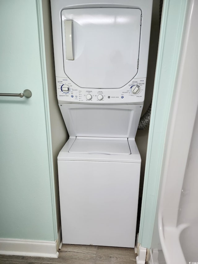 5308 N Ocean Blvd Unit 812, Myrtle Beach, SC 29577 - laundry room with estacked washer and dryer, wood finished floors, and baseboards