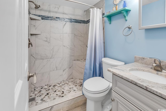 bathroom with a shower with curtain, vanity, and toilet