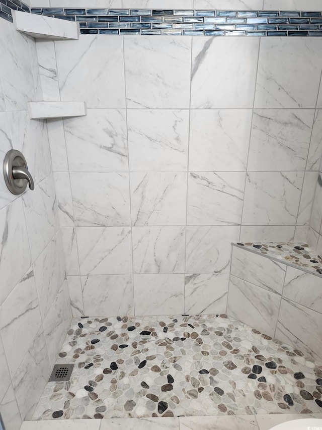 bathroom with tiled shower