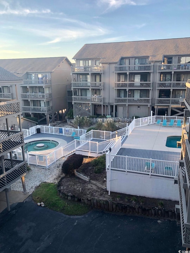 view of swimming pool with a patio and a community hot tub