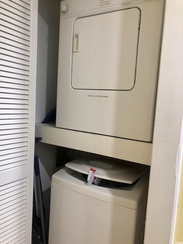 clothes washing area with stacked washer / drying machine