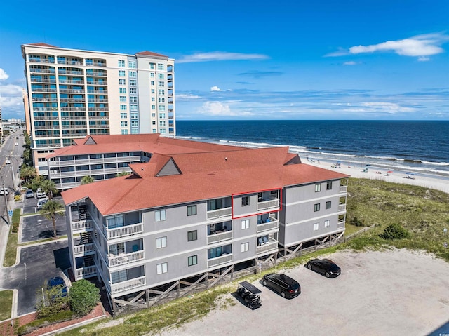 aerial view with a water view and a beach view