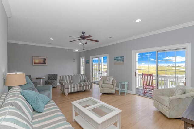 living room with crown molding, light wood-style flooring, and ceiling fan