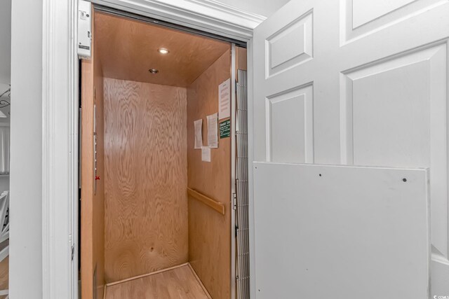 interior details with elevator and wood finished floors