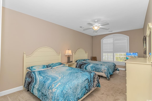 bedroom featuring ceiling fan and light carpet