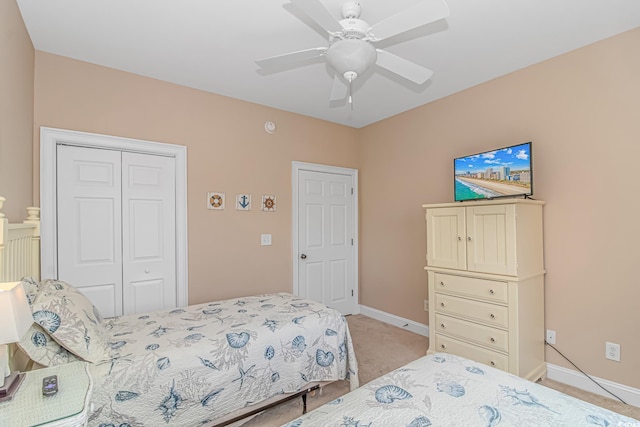 carpeted bedroom with a closet and ceiling fan