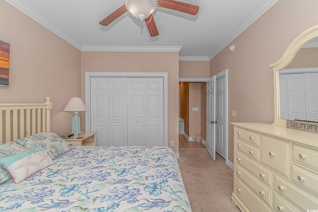 carpeted bedroom with ornamental molding and ceiling fan