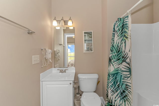 bathroom with vanity, toilet, and curtained shower