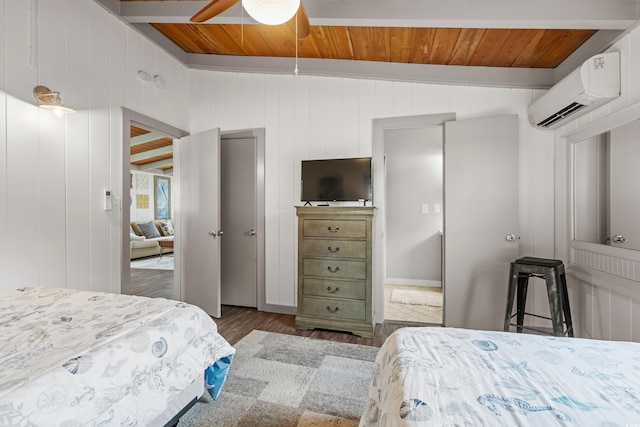 bedroom featuring dark wood-type flooring, an AC wall unit, ceiling fan, and wood walls