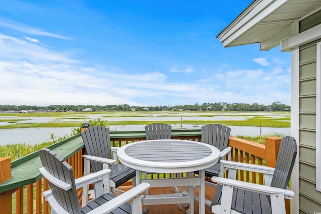 wooden terrace featuring a water view