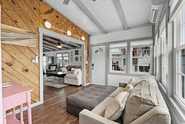 living room featuring beam ceiling, ceiling fan, dark wood-type flooring, and wooden walls