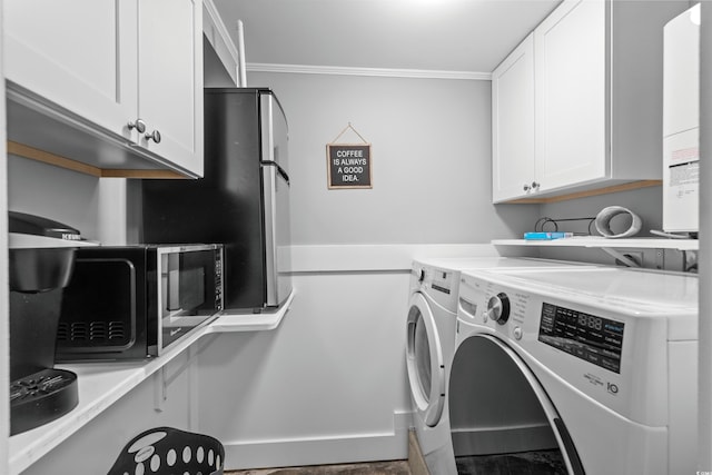 washroom featuring independent washer and dryer, crown molding, and cabinets