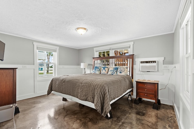 bedroom with crown molding, a wall mounted air conditioner, and a textured ceiling