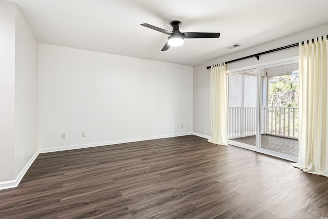 empty room featuring ceiling fan, baseboards, and dark wood finished floors