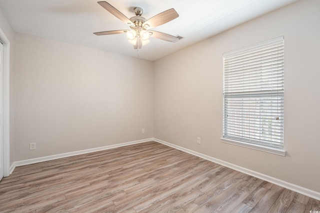 empty room featuring light wood-type flooring, ceiling fan, and baseboards