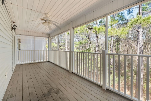 unfurnished sunroom with a ceiling fan