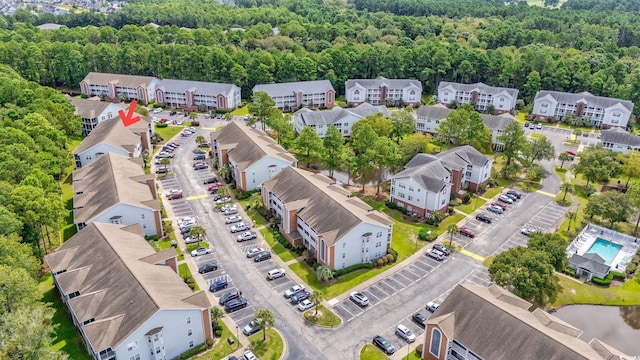 drone / aerial view with a forest view and a residential view