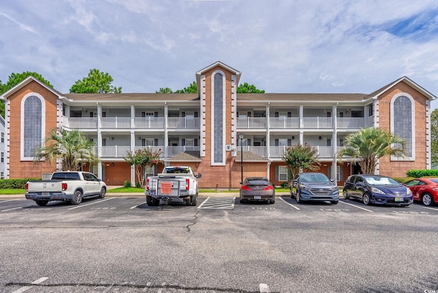 view of building exterior featuring uncovered parking