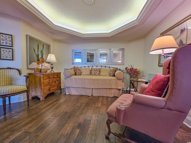 living room featuring ornamental molding, a textured ceiling, a raised ceiling, and dark hardwood / wood-style floors