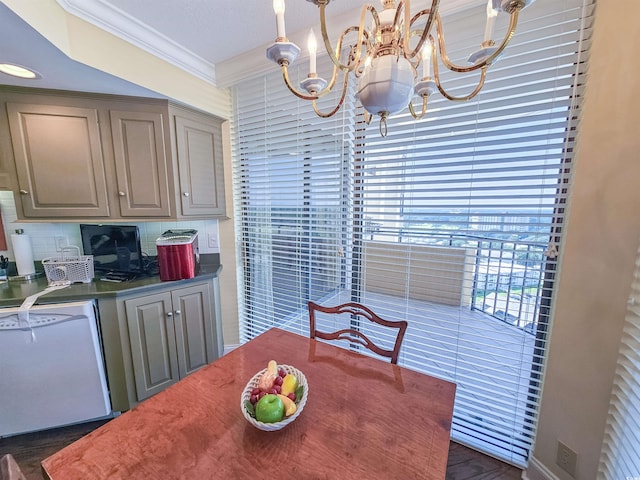 dining room with a notable chandelier, crown molding, and dark hardwood / wood-style flooring