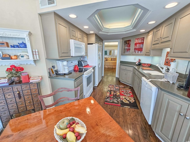 kitchen featuring gray cabinets, a tray ceiling, and white appliances