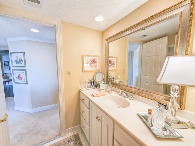 bathroom featuring vanity, a textured ceiling, and tile patterned flooring