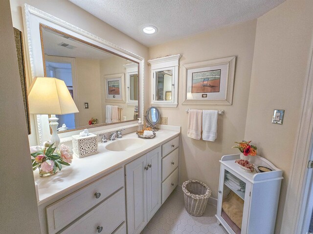9650 Shore Dr Unit 1906, Myrtle Beach, SC 29572 - bathroom featuring visible vents, a textured ceiling, recessed lighting, tile patterned flooring, and vanity