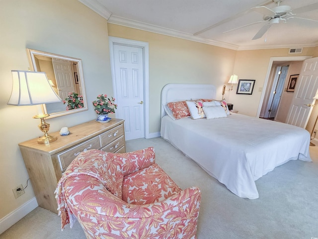 carpeted bedroom with crown molding and ceiling fan