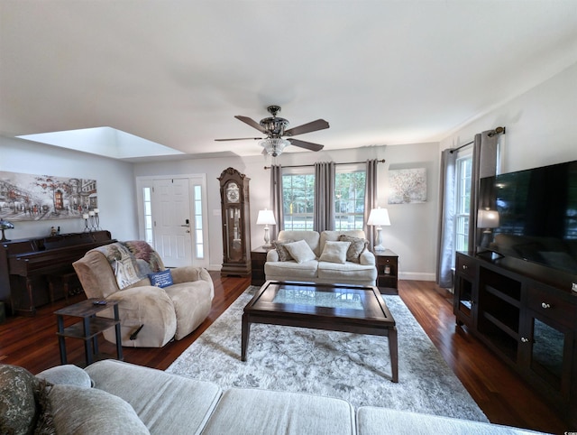 living room with dark wood-type flooring and ceiling fan