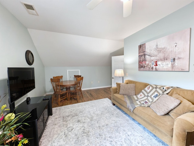 living room with ceiling fan, hardwood / wood-style flooring, and vaulted ceiling